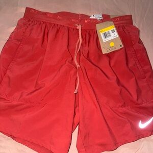 New With tags Men’s Nike Red Running Shorts. Size small.  Salmon color
